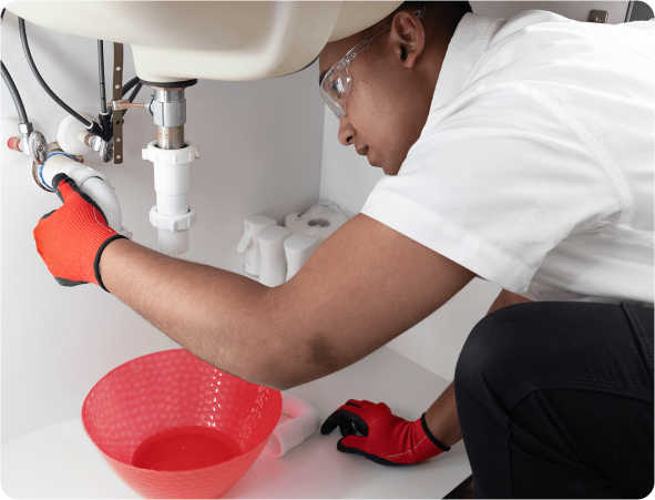 plumber under bathroom sink